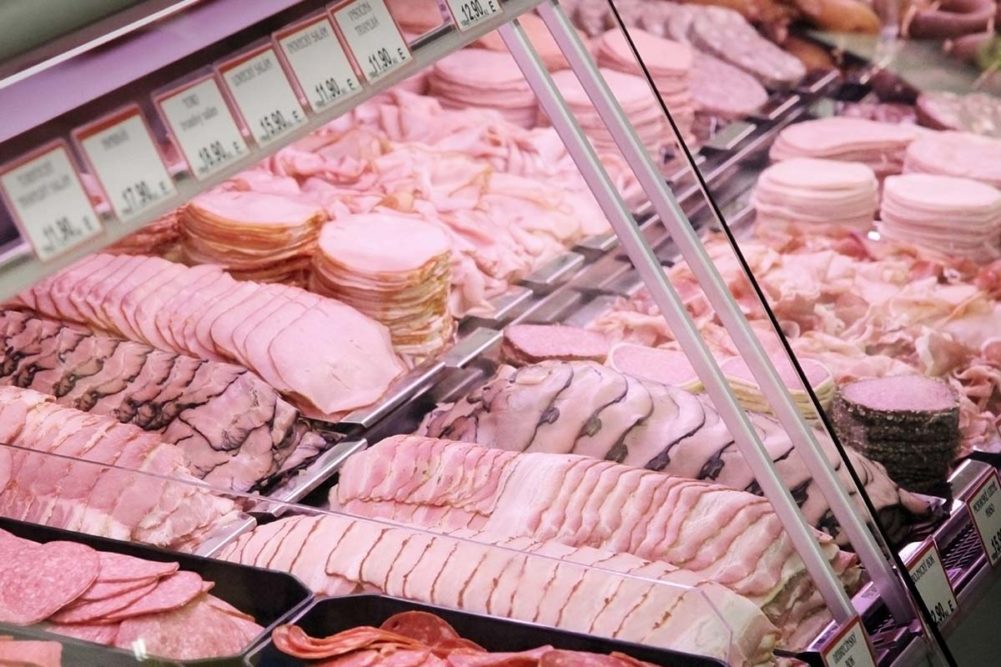 sliced deli meats in a glass case