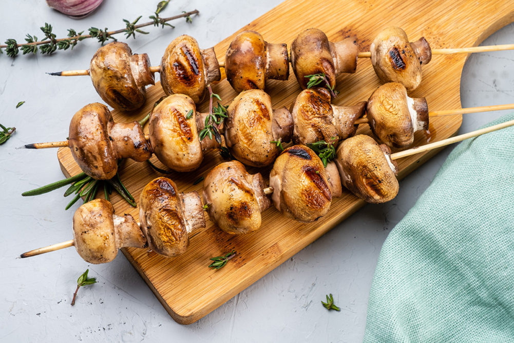 Roasted mushroom skewers, vegan barbecue, healthy eating. Top view.