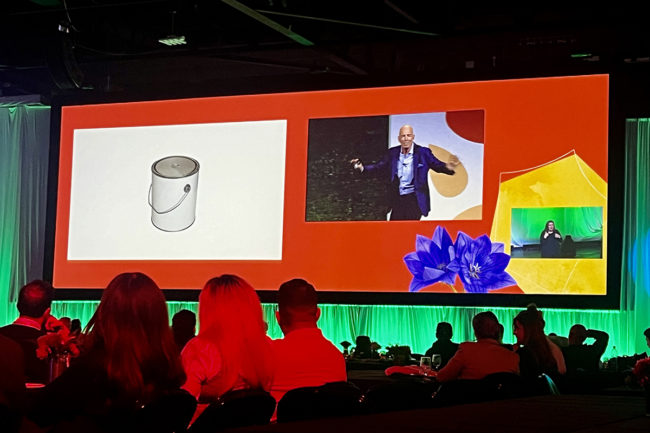 Marc Randolph, Netflix’s co-founder and first CEO on a stage with an image of a paint can on a screen