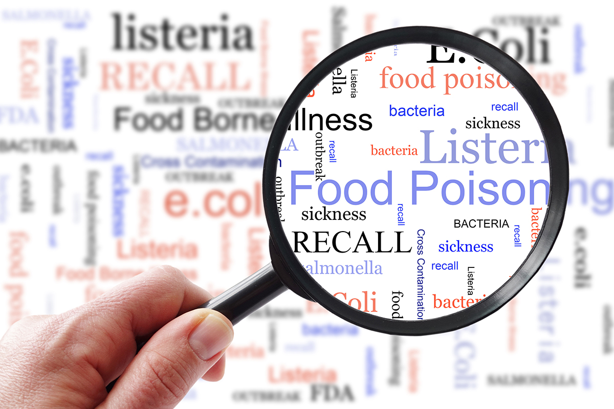 Food poisoning related terms, salmonella, e coli, listeria, food safety, recall, etc. in a word cloud with magnifying glass